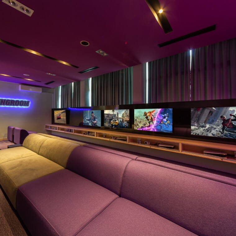 Interior of a gaming room with large screens and seating area