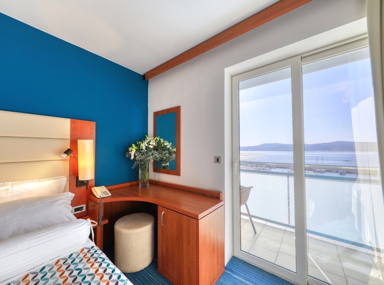 Camera d’albergo con scrivania e accesso al balcone