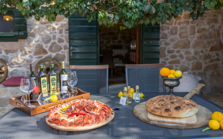outdoor table with food and drinks in the villa courtyard