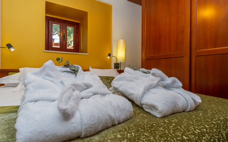comfortable bedroom with double bed and bathrobes