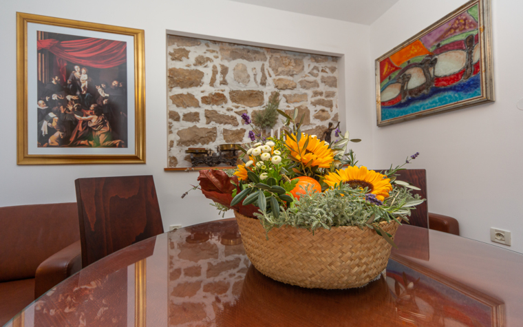 dining table with floral arrangement in a rustic interior