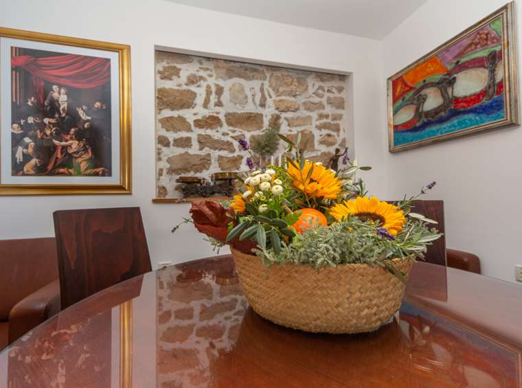 dining table with floral arrangement in a rustic interior