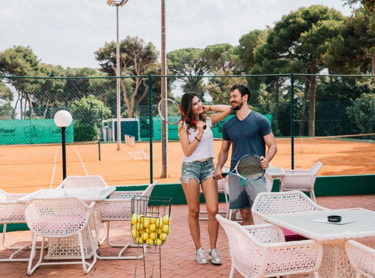 teniška igrišča z igralci obdana z zelenjem