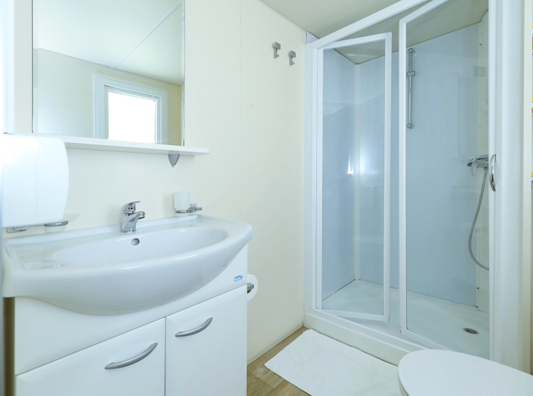 modernes Badezimmer im Mobilheim mit Dusche, Waschbecken und WC