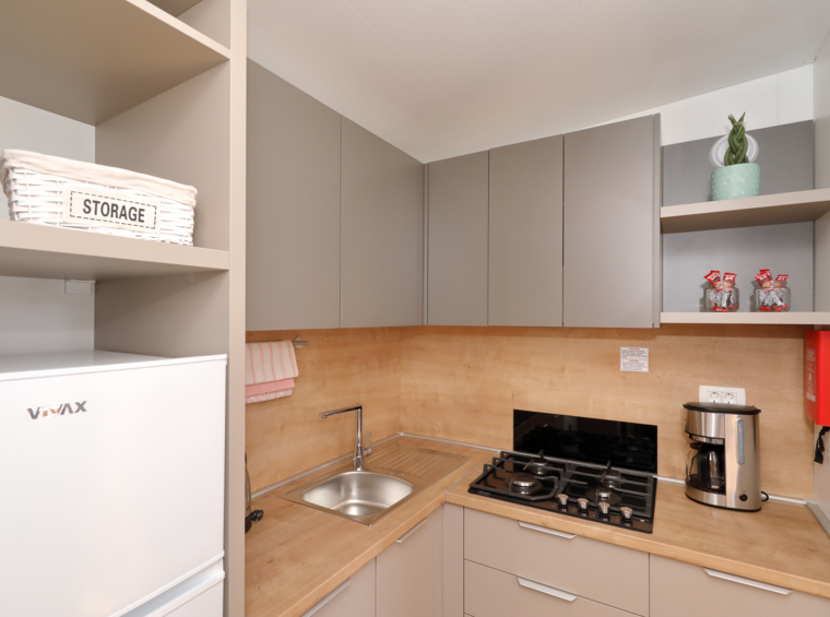 compact mobile home kitchen with appliances and worktop