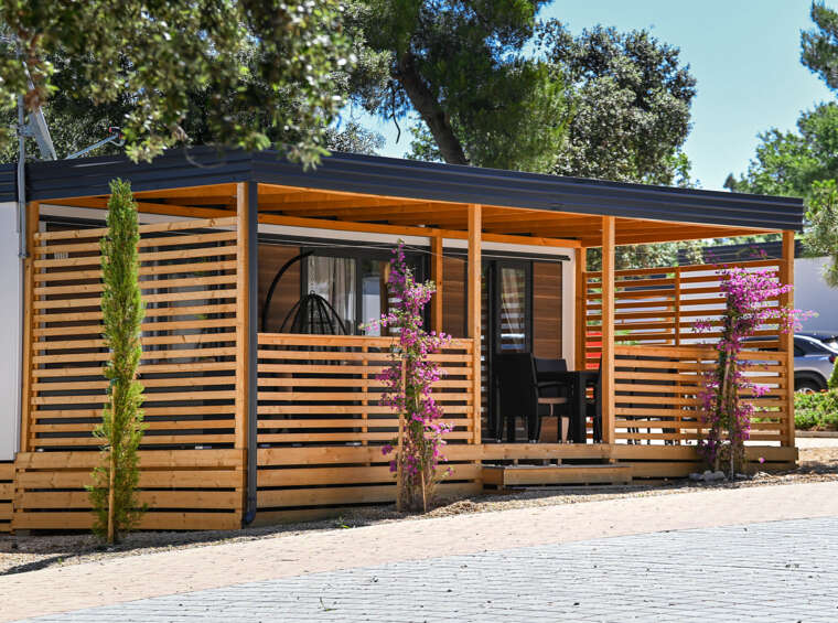 modern mobile home with wooden facade and terrace