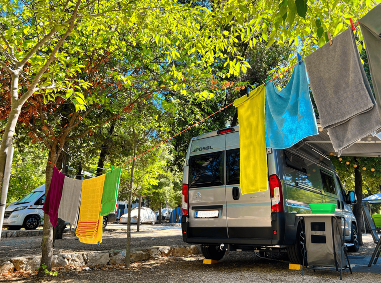 camper pitch in tree shade with space for drying clothes