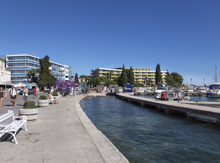 seaside promenade in tourist town with marina